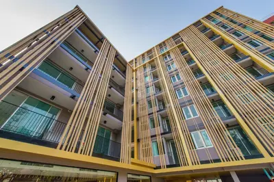 two tall apartment buildings with balconies at Zenniq in Bangkok