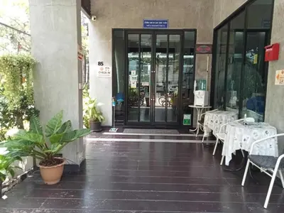 an entrance to a building with tables and chairs at Collection O The Bangkok Cha Cha Suite in Bangkok