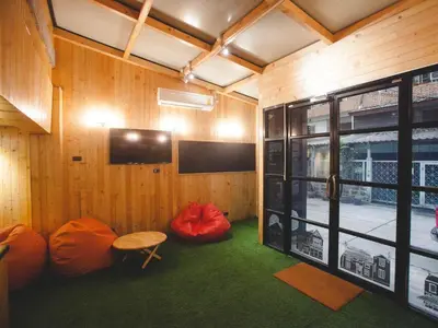 a room with red bean bags and a window at Double Five in Bangkok
