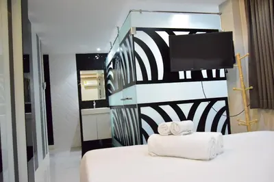 a hotel room with a bed with towels on it at Double Five in Bangkok