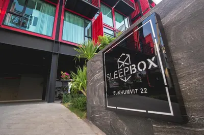 a sign for the exterior of a building at Sleep Box Hotel Sukhumvit 22 in Bangkok