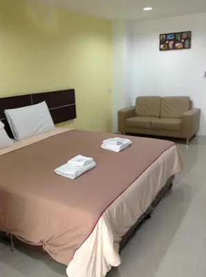 a bedroom with a large bed with two towels on it at Diamond Bangkok Apartment in Bangkok