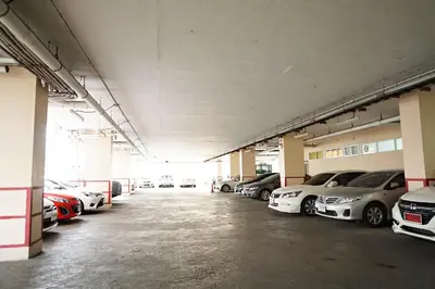 a large parking lot with cars parked in it at Diamond Bangkok Apartment in Bangkok