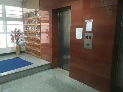 a elevator in a building with a blue mat on the floor at Diamond Bangkok Apartment in Bangkok