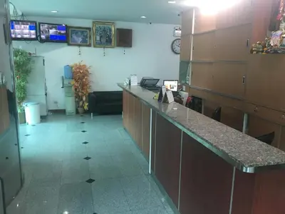 a kitchen with a long counter in a room at Diamond Bangkok Apartment in Bangkok