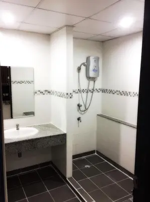 a bathroom with a sink and a shower at Diamond Bangkok Apartment in Bangkok