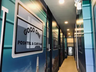 a hallway with a sign on the side of a building at Good One Poshtel & Cafe Bar in Bangkok