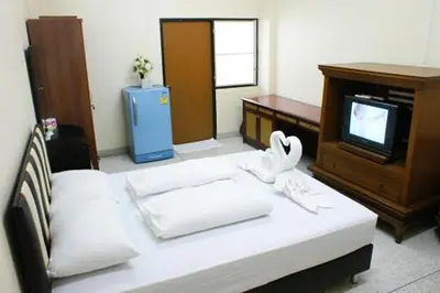 a hotel room with a bed and a tv at Kim Hotel At Bangplong in Bangkok