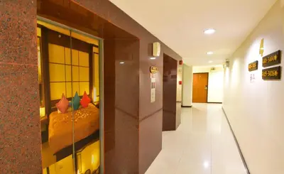 a hallway of a building with a glass window at Grand Business Inn in Bangkok