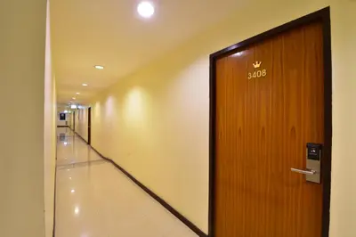 an office corridor with a door with the number on it at Grand Business Inn in Bangkok