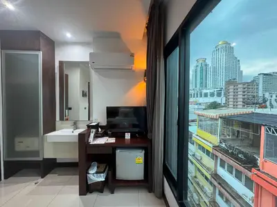 a bathroom with a sink and a large window at Collection O The Bangkok Airport Link Suite in Bangkok