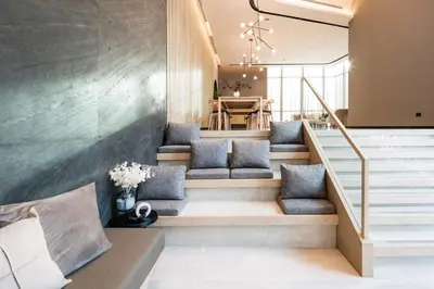 a living room with stairs and a dining room at Mii Hotel Srinakarin in Bangna