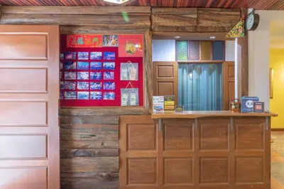 a room with wooden walls and a wooden door at Banthat Thong Hostel in Bangkok