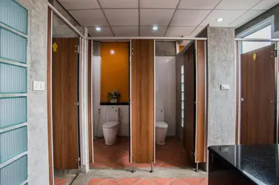 a bathroom with two toilets in a room at Banthat Thong Hostel in Bangkok