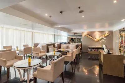 a restaurant with tables and chairs in a room at Furama Silom Hotel in Bangkok