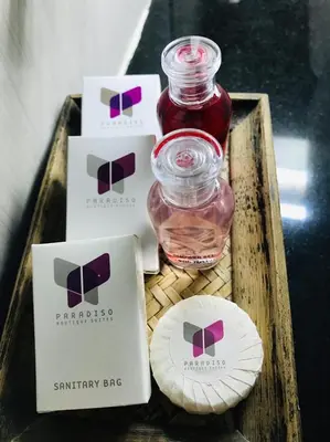 a bottle of jam sitting on a wooden tray with boxes at Paradiso Boutique Suites in Bangkok