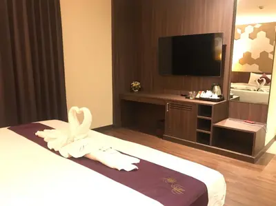 a hotel room with a bed and a large mirror at Paradiso Boutique Suites in Bangkok