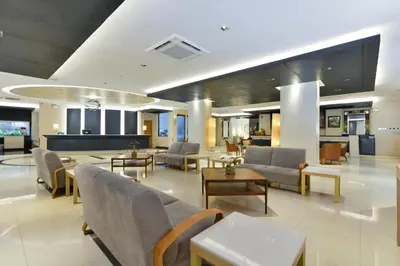 a lobby with couches and tables in a hospital at Royal View Resort - Rang Nam in Bangkok