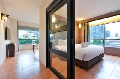 a bedroom with a bed and a large mirror at Royal View Resort - Rang Nam in Bangkok