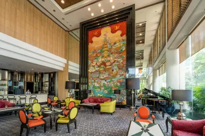 a lobby with a large christmas tree on the wall at Century Park Hotel in Bangkok