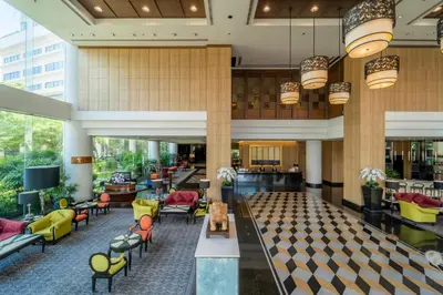 a lobby of a hotel with colorful chairs and tables at Century Park Hotel in Bangkok