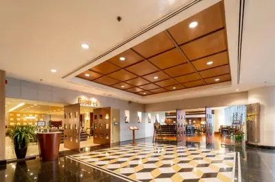 a hotel lobby with a checkered floor at Century Park Hotel in Bangkok