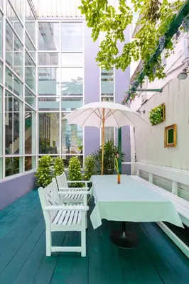 a table and chairs on the roof of a building at Pinnacle Lumpini Park Hotel in Bangkok