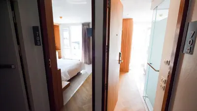 a room with a bedroom with a bed and a mirror at Pinnacle Dream in Bangkok