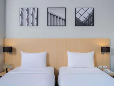 two beds sitting next to each other in a room at Ibis Bangkok Sukhumvit 4 in Bangkok