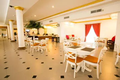 a dining room with white tables and chairs at Hope Land Hotel 46/1 in Bangkok