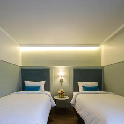 two beds sitting next to each other in a room at The Mulberry Bangkok Khaosan Road in Bangkok