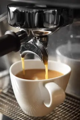 a coffee maker is making a cup of coffee at Khaosan Palace Hotel in Bangkok