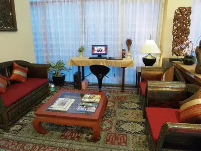 a living room with a couch and a table at De Arni Bangkok - SHA Extra Plus in Bangkok