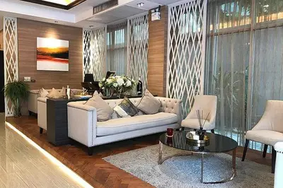a living room with a white couch and a table at De Arni Bangkok - SHA Extra Plus in Bangkok