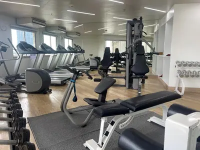 a gym with lots of treadmills and exercise bikes at Riverfront Bangkok in Bangkok