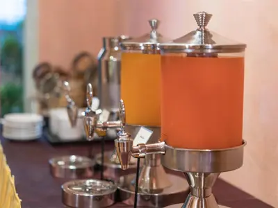 a juicer with a drink in it on a table at Riverfront Bangkok in Bangkok