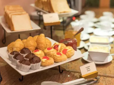 a display of pastries and cakes on a table at Riverfront Bangkok in Bangkok