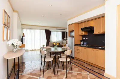 a kitchen and dining room with a table and chairs at Riverfront Bangkok in Bangkok