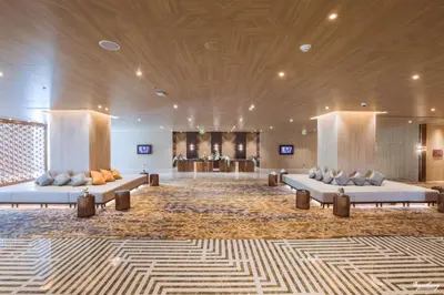a lobby with couches and tables in a building at Grand Richmond Stylish Convention Hotel in Nonthaburi