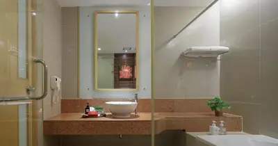 a bathroom with a sink and a mirror at Grand Richmond Stylish Convention Hotel in Nonthaburi