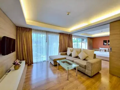 a living room with a couch and a table at Olive Hotel & Residence Bangkok Sukhumvit 101 near True Digital Park in Bangkok
