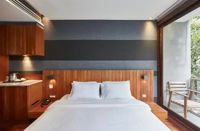 a bedroom with a large bed with a black and white wall at LUXX Langsuan Hotel - SHA Plus in Bangkok