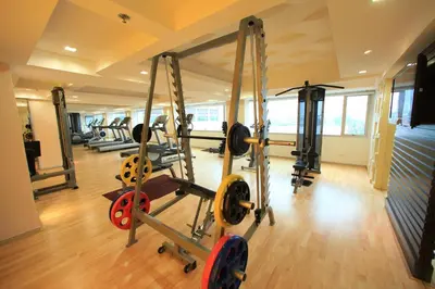 a gym with several tread machines in a room at Ramada Plaza by Wyndham Bangkok Menam Riverside in Bangkok