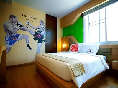a bedroom with a large bed with a poster on the wall at Ds67 Suites in Bangkok