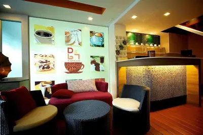 a living room with a red couch and chairs at Ds67 Suites in Bangkok