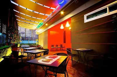 a restaurant with tables and chairs in a room at Ds67 Suites in Bangkok