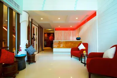 a hallway with two red chairs and a waiting room at Ds67 Suites in Bangkok
