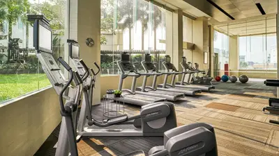 a row of treadmills in a gym at JC Kevin Sathorn Bangkok Hotel in Bangkok
