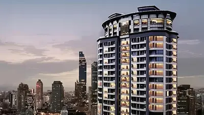 a tall building with lights on in a city at JC Kevin Sathorn Bangkok Hotel in Bangkok