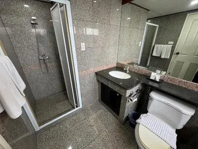 a bathroom with a shower and a toilet and a sink at Collection O The Step Sathorn in Bangkok